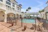 Common Balcony with dual curved staircases coming toward the pool area.