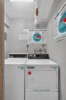 Dedicated laundry room featuring a top-loading washing machine and a front-loading dryer