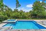 Backyard pool and spa with paver deck and fenced yard