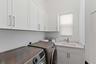 Laundry room with washer, dryer, and farmhouse sink