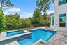 Backyard pool and spa view with paver deck near the house