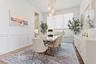 Dining area with table, upholstered chairs, and modern pendant lighting