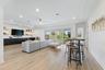 Bonus room with kitchenette, seating area, and high-top bar table with stools