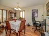 Dining space with crown molding, a chandelier, and wood finished floors