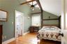 ceiling fan, vaulted ceiling with beams, and light hardwood floors