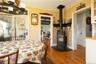 Dining area featuring ornamental molding, hardwood / wood-style floors, ,and a wood stove
