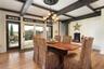 Dining space with  beamed ceiling, light hardwood / wood-style flooring, and coffered ceiling and a propane fire;place