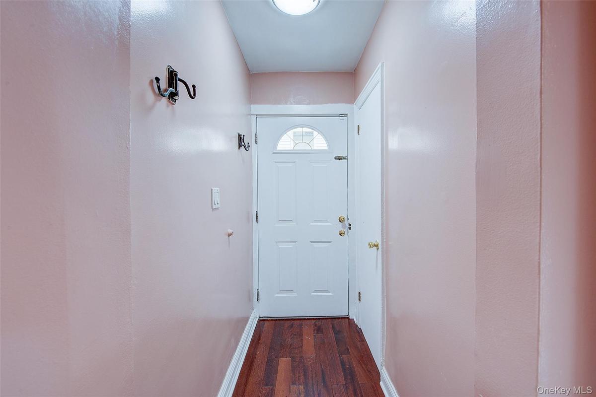 Front door, adjacent to it is a closet