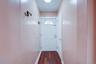 Front door, adjacent to it is a closet