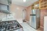 whirlpool fridge and extra storage, kitchen leads to hallway