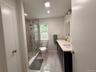 New Primary Bathroom with double sinks and pretty floor