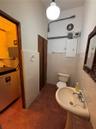 1st floor half bathroom with utility closets and electrical panels.