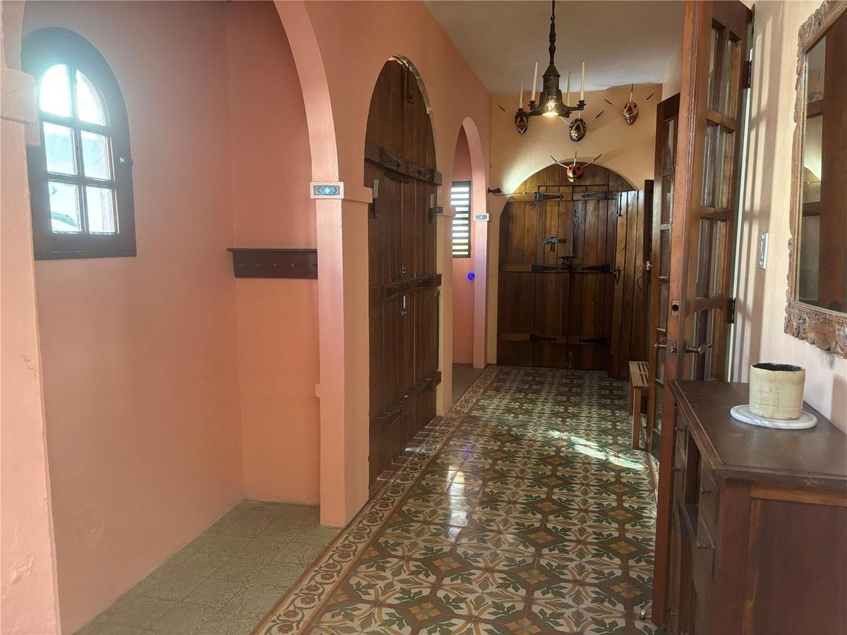 Entry foyer has a grand wooden door and two alcoves for added space.