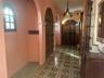 Entry foyer has a grand wooden door and two alcoves for added space.