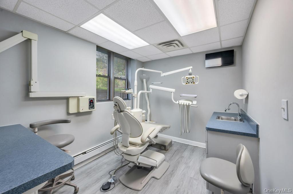 Dedicated clinical space featuring recessed lighting, paneled ceilings, and wood-finish flooring