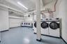 On-site laundry room featuring multiple commercial-grade washers and dryers
