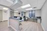 Reception area featuring wood-finish flooring, a suspended ceiling with recessed lighting, and a built-in curved counter with a blue countertop