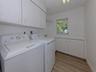 The laundry room is large and offers plenty of extra storage