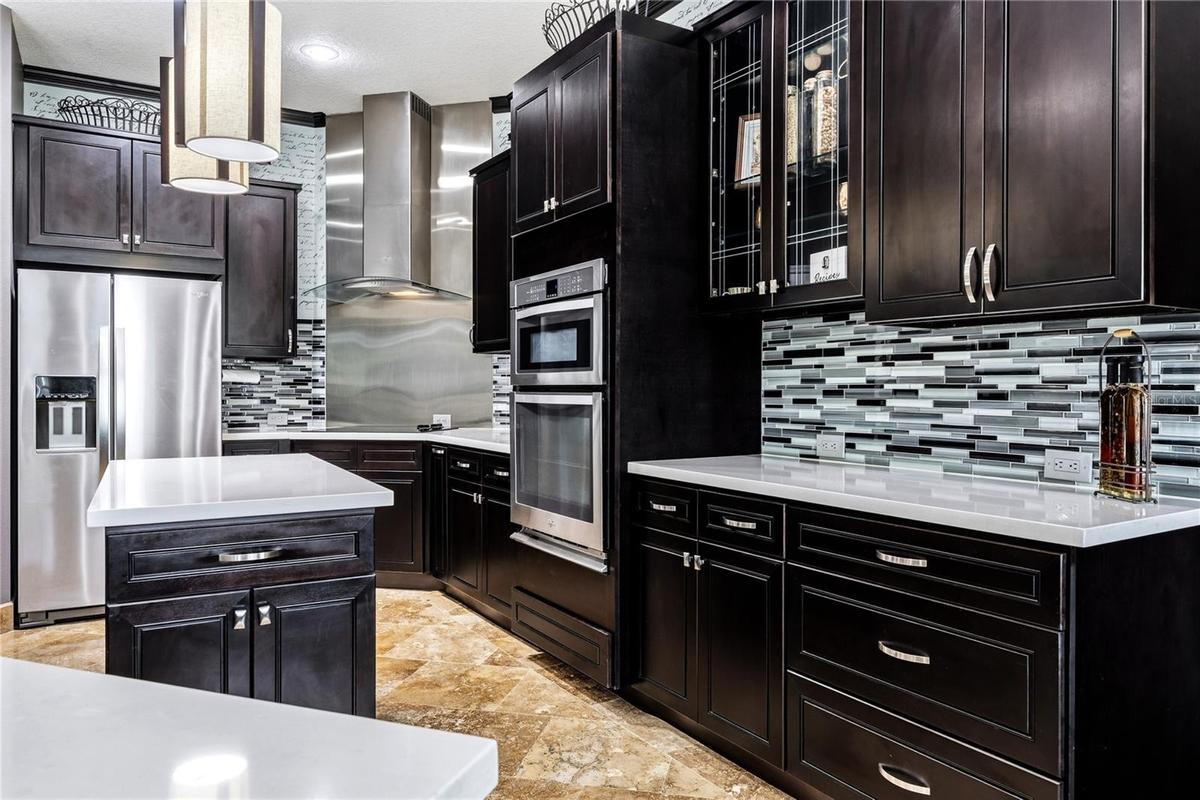 Lots of cabinetry with glass front accent and soft close.