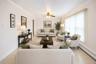 VIRTUALLY STAGED. Spacious living area featuring light-toned walls, crown molding, and tiled flooring
