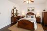 Hardwood-finish flooring, white painted walls, and crown molding