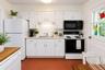 Kitchen featuring white cabinetry, a stainless steel sink, and light-toned countertops