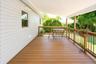Covered outdoor deck with wood-finish flooring