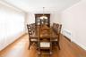 Spacious room featuring wood-finish flooring and crown molding