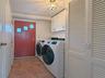 Dedicated laundry area featuring modern front-loading appliances