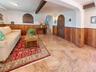 Spacious living area featuring large format tile flooring and wood paneling