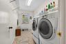 Just beyond the washer and dryer is a utility sink and access to the garage