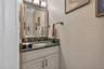 Lovely powder room conveniently located in the hallway to the laundry room