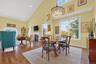 Dining space featuring high vaulted ceiling, wood-type flooring, recessed lighting, and a fireplace