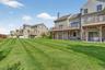 Rear view of property with a yard, a chimney, a patio area, a residential view, and a wooden deck