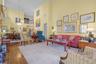 Living room featuring a high ceiling, hardwood / wood-style flooring, stairway, and crown molding