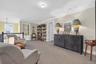 Sitting room with carpet flooring, crown molding, and an upstairs landing