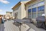 Wooden terrace featuring a grill and an outdoor living space
