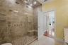 Luxurious primary bath featuring a spacious spa-inspired shower with sleek modern finishes