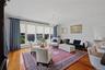 Spacious living room with beautiful large windows creating an airy, open atmosphere