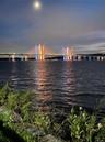 Stunning evening views of the illuminated bridge reflecting across the river