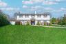 Colonial inspired home with a chimney, a front lawn, and fence