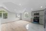 Open-concept living space with vaulted ceilings and recessed lighting