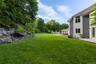 Flat, fenced back garden that is perfect for a soccer game or tented event