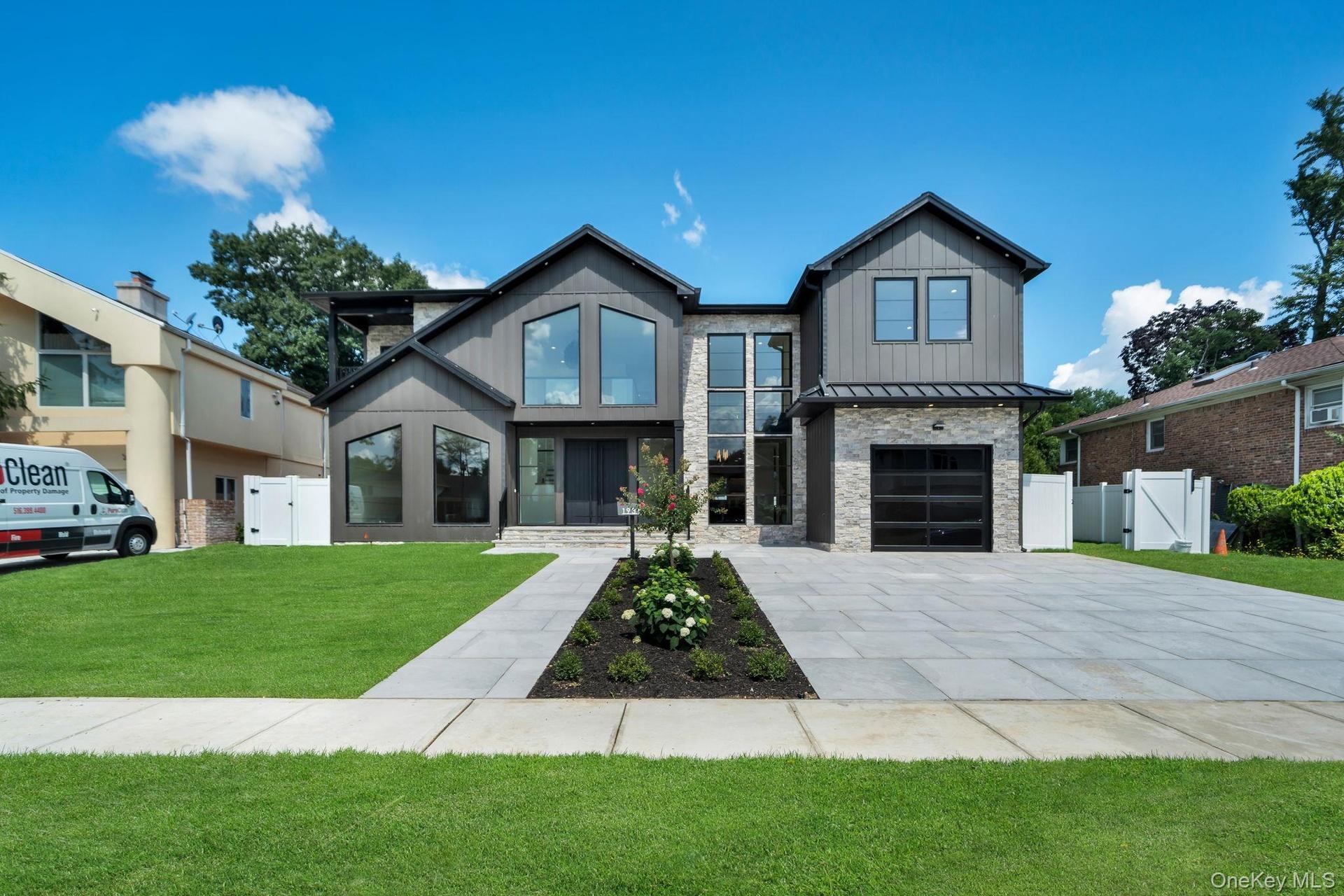 Contemporary exterior featuring dark vertical siding and stone accents