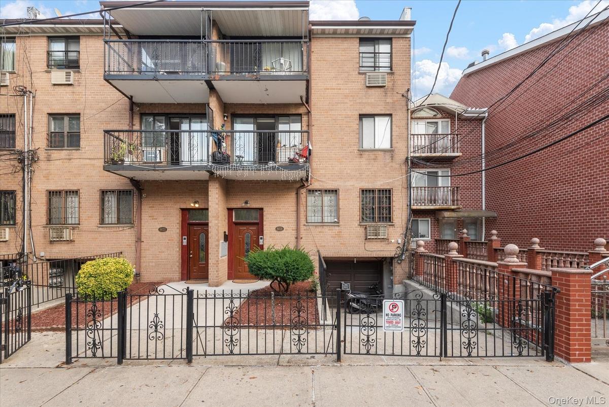 Brick facade building featuring multiple private balconies with black metal railings