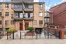 Brick facade building featuring multiple private balconies with black metal railings