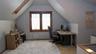 Third floor, room with sloped ceilings and light wood-finish flooring