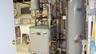 Utility area featuring a boiler, water heater, and a utility sink