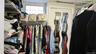 Custom walk-in closet system featuring wire shelving and hanging rods