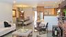 Open-concept living space featuring light gray walls and recessed lighting